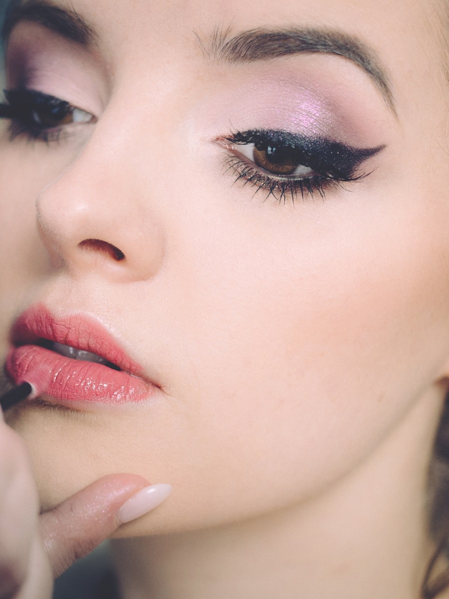 Make-up artist applying lipstick to a client